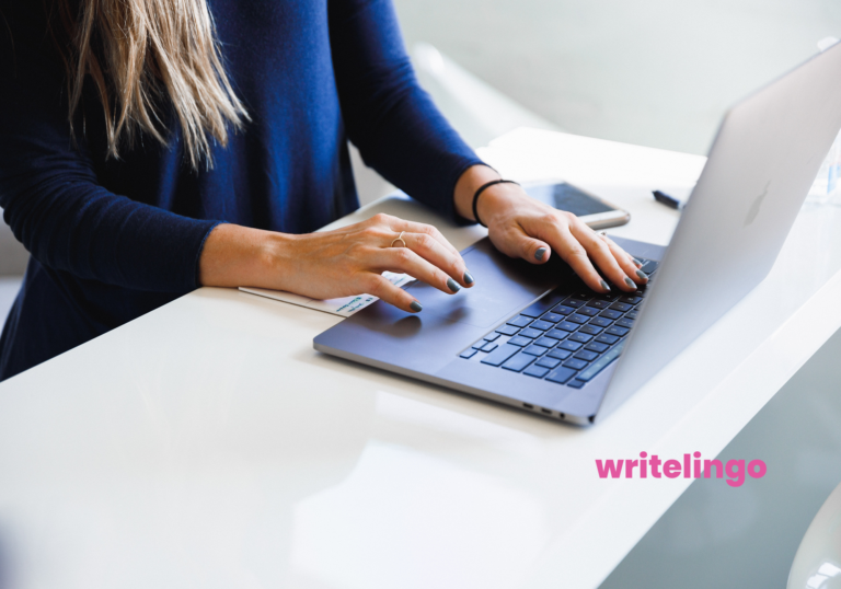 a copywriter typing on a laptop using an AI writing tool